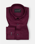 A maroon colored, long-sleeved, button-down linen shirt by Frankish.