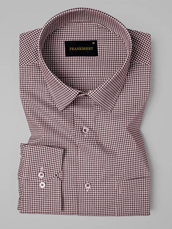 Folded checkered shirt with brand label on a gray background