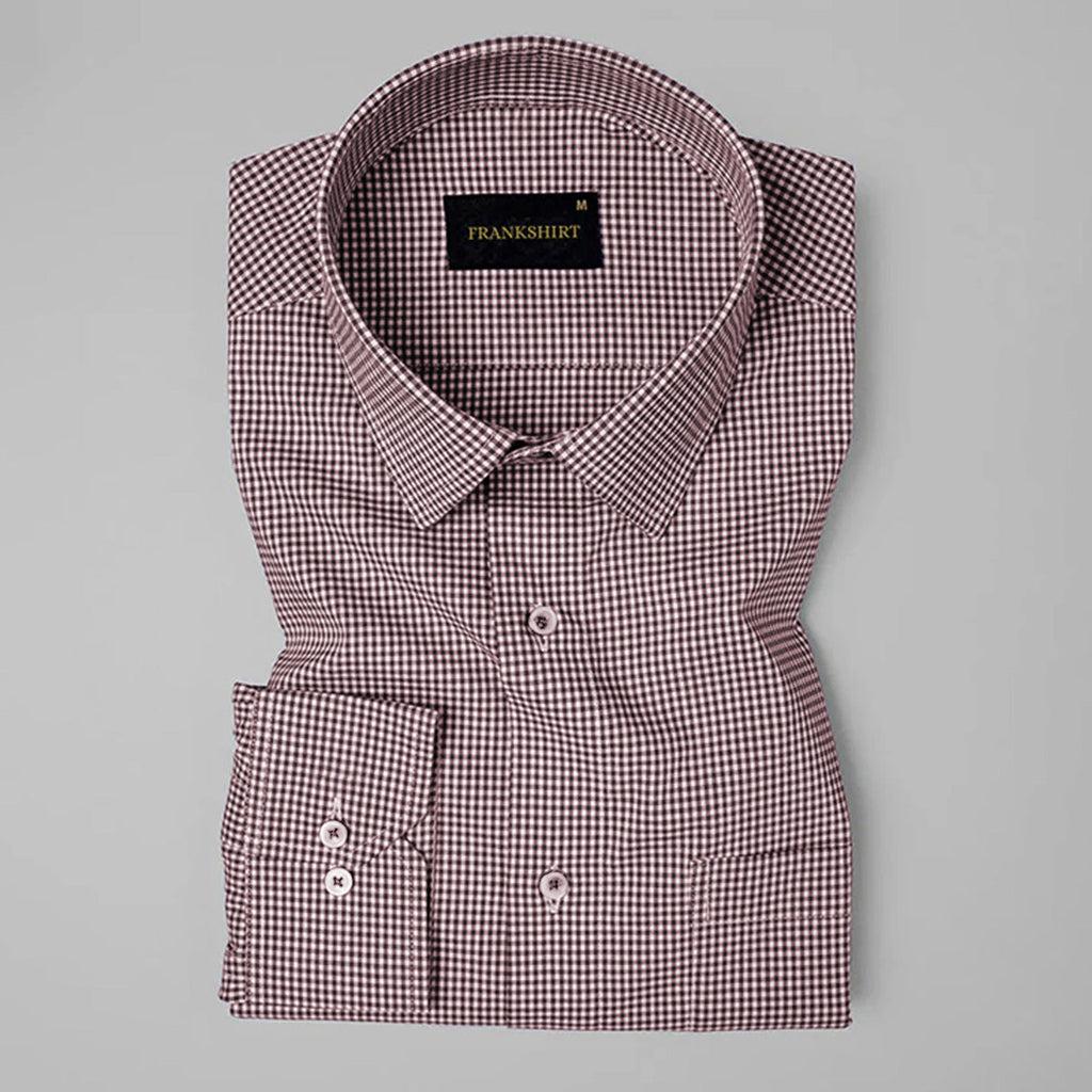 Folded checkered shirt with brand label on a gray background