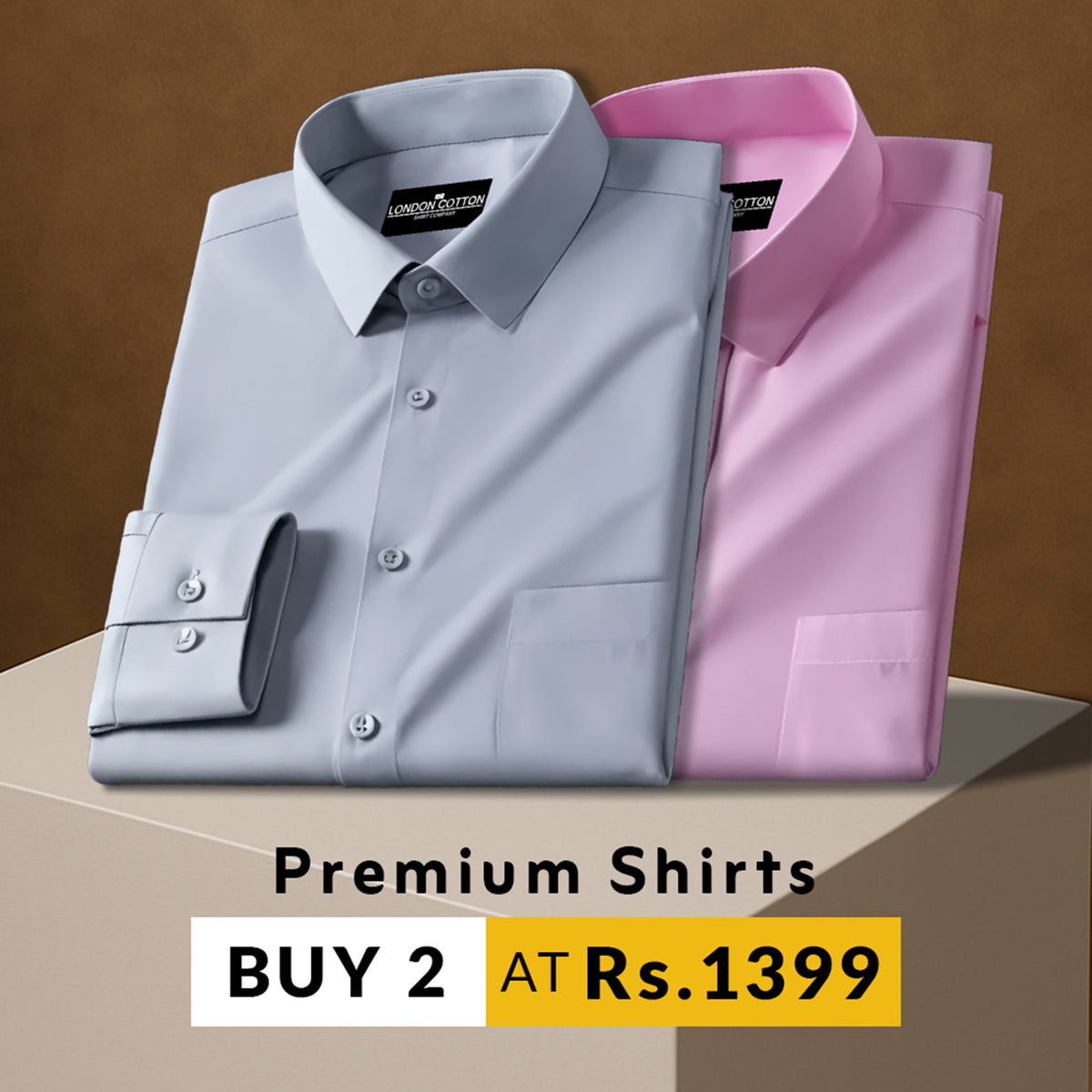 Two folded shirts, one gray and one pink, on a brown background with promotional text.