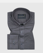 A dark grey, long-sleeved, button-down linen shirt by Frankshirt displayed against a white background.