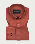 A brown, long-sleeved, button-down linen shirt by Frankshirt laid out flat on a white background.