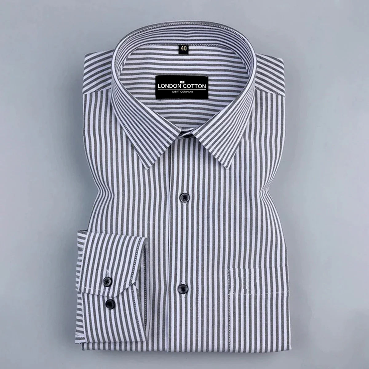 Folded black and white striped shirt with 'London Cotton' label on a gray background