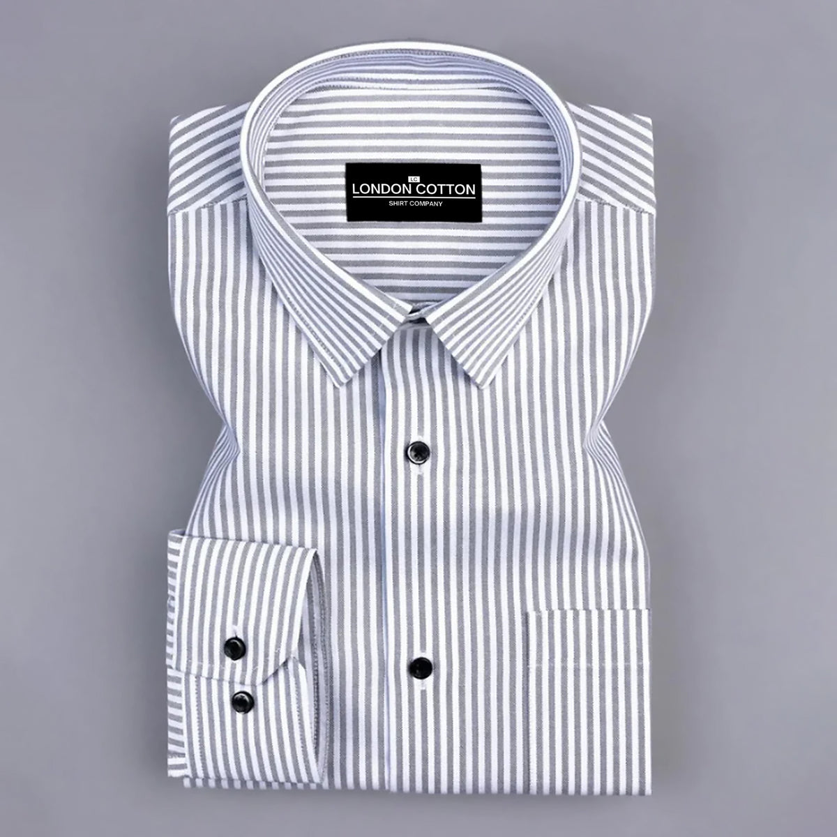 Folded white shirt with blue stripes on a gray background