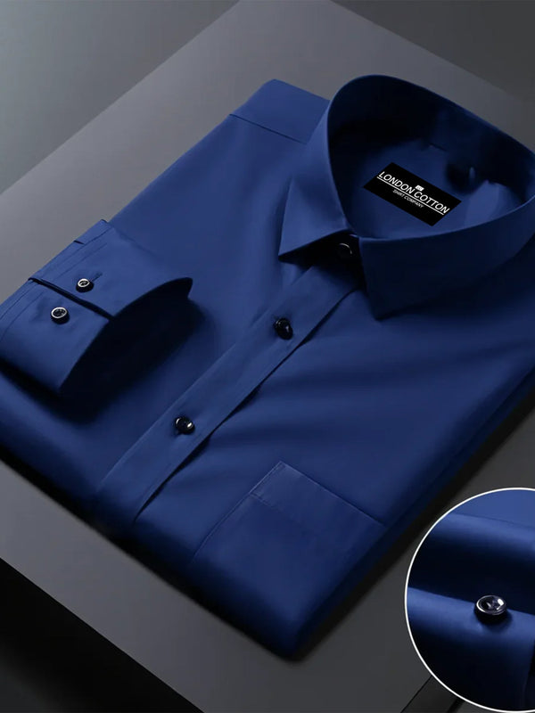 Folded blue shirt with a close-up of buttons on a dark surface