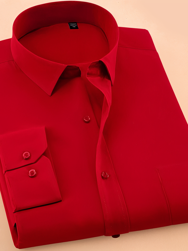 A folded red colored cotton shirt with long sleeves and a collar.